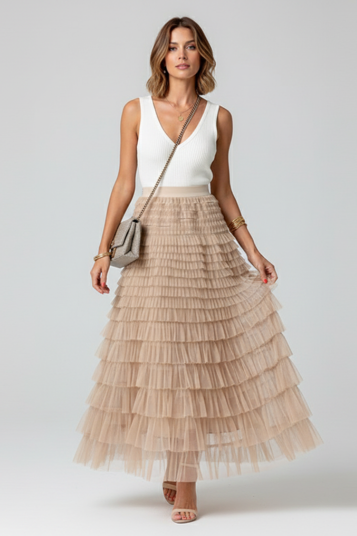 Flowy tiered midi skirt with a comfortable high elastic waist, featuring romantic ruffles.