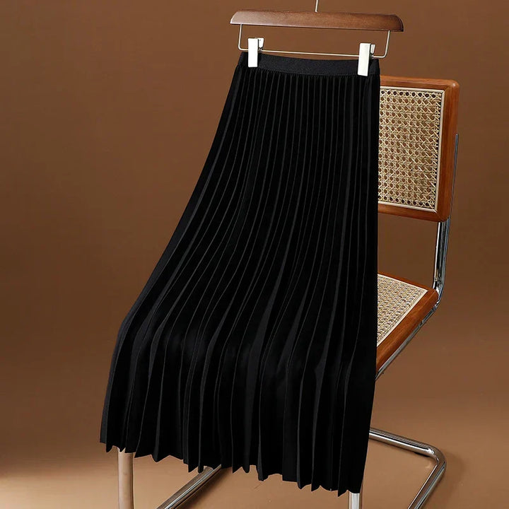 Women's elegant high-waist pleated midi skirt in motion. Showcasing flowy movement & versatile classic style.