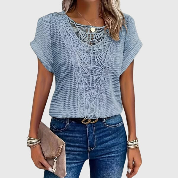 Detail of the long sleeves and lace fabric on an elegant women's Ibiza style summer blouse.