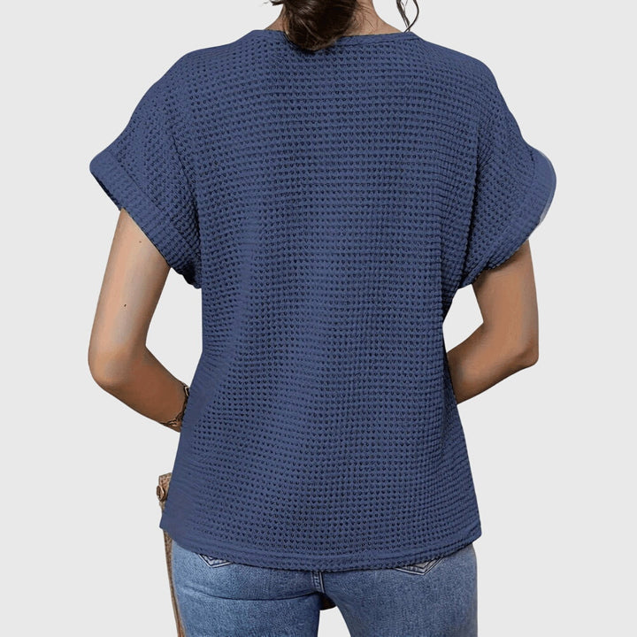 Close-up of the delicate lace detail on an elegant women's Ibiza style long-sleeve blouse.