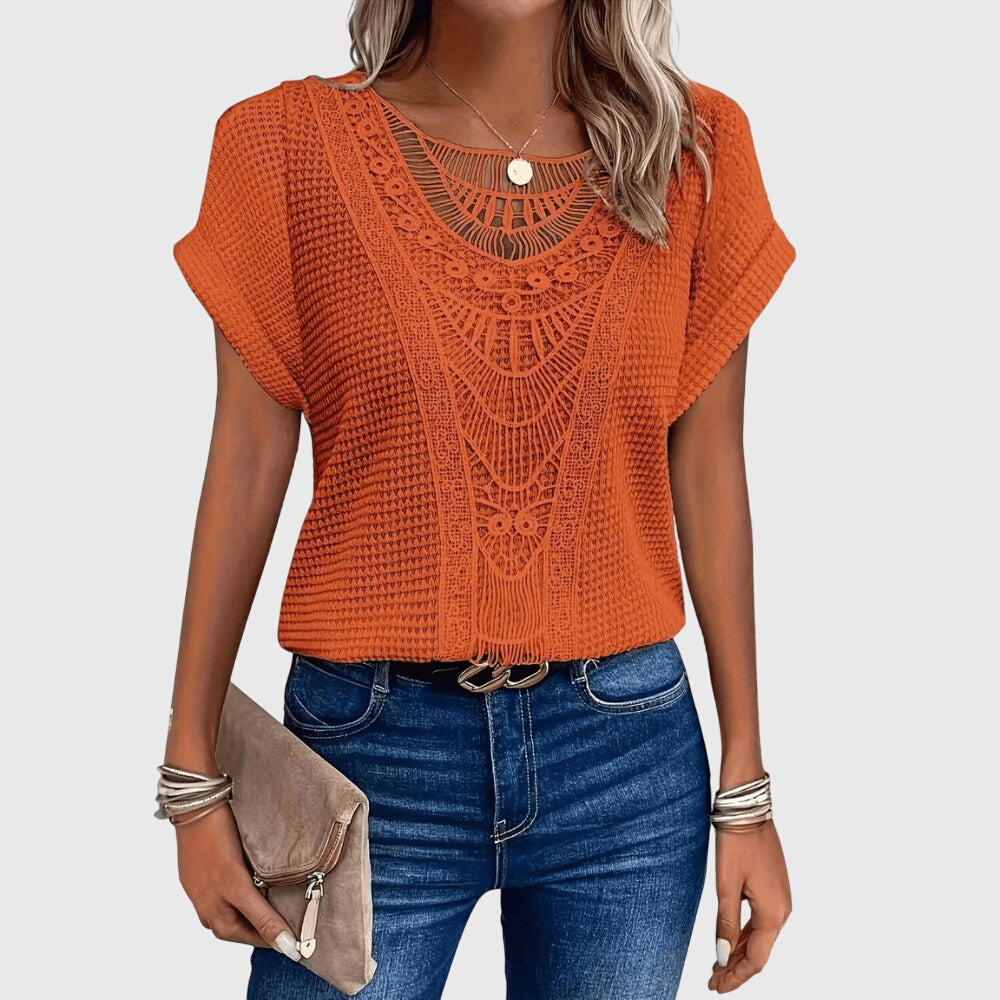 Full view of a woman wearing a flowy, elegant long-sleeve lace blouse in classic Ibiza style.