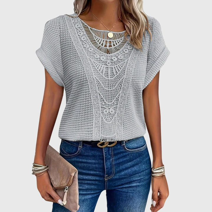 Back view of a women's elegant long-sleeve lace blouse, showcasing its flowy Ibiza style.