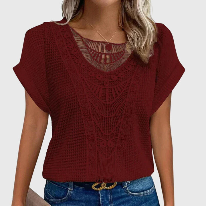 Front view of an elegant women's Ibiza style lace blouse. A versatile, flowy long-sleeve fashion top.