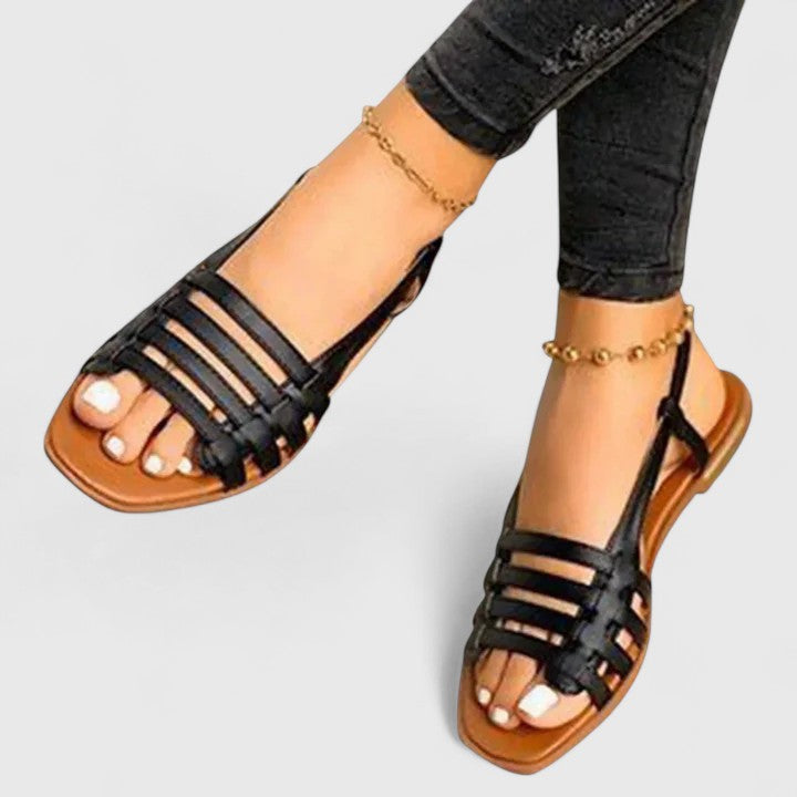 Women's fashion-forward metallic woven flat slingback sandals, offering open-toe comfort & elegant summer style.