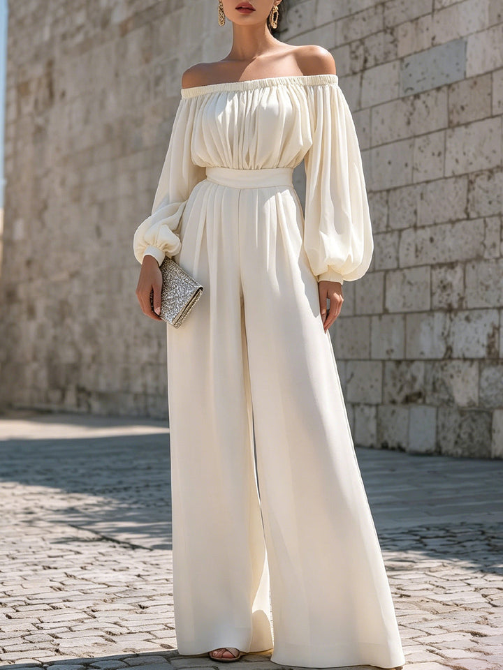 Elegant off-shoulder white maxi dress with bishop sleeves, perfect for wedding guests or resort wear.