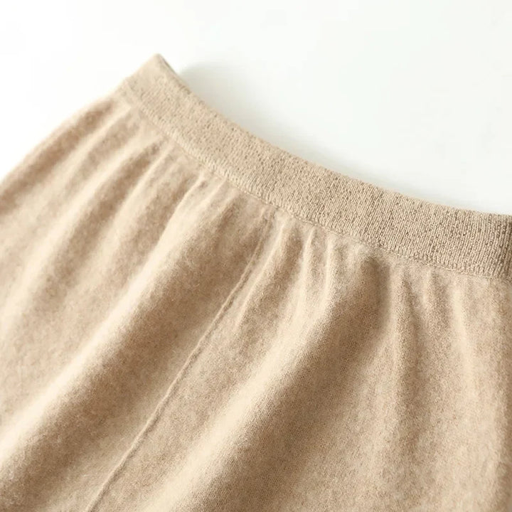 Olive merino wool knit maxi skirt showing the subtle sheen of the high-quality natural fibers.