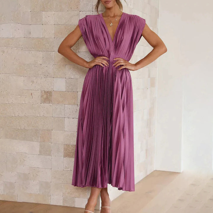Beautiful pleated V-neck midi dress for stylish spring wedding guests.