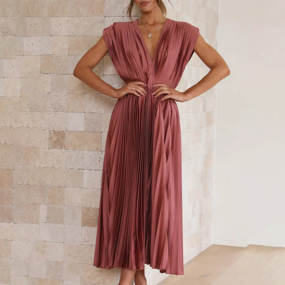 Flowy pleated V-neck midi dress, a beautiful option for a summer wedding guest.