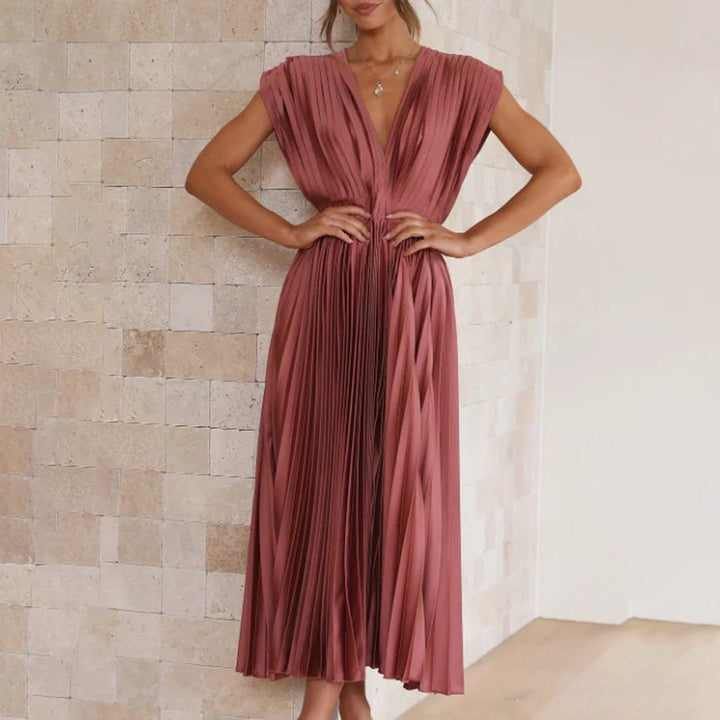 Flowy pleated V-neck midi dress, a beautiful option for a summer wedding guest.