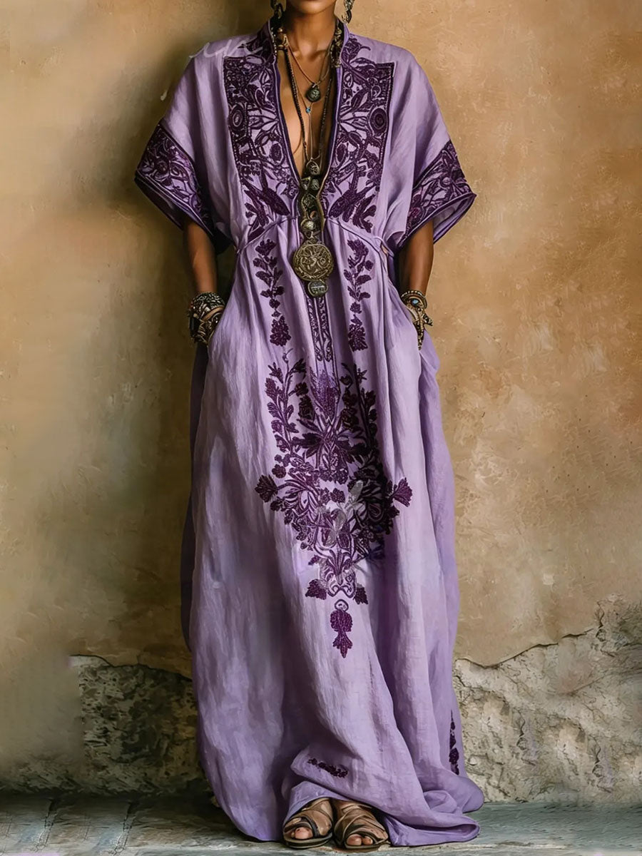 Elegant purple kaftan maxi dress for women, featuring a beautiful embroidered floral print and flowing batwing sleeves.