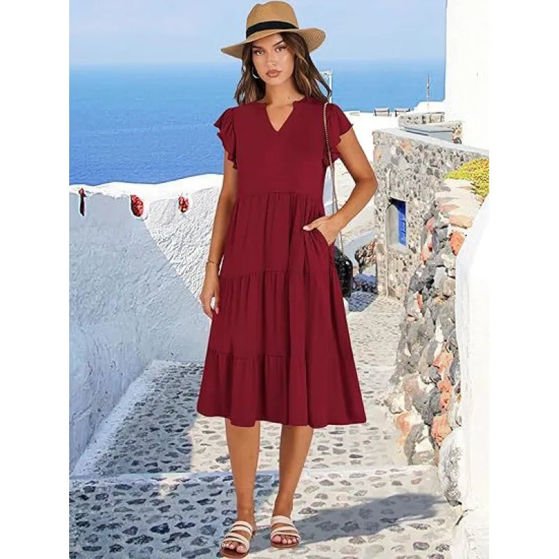 Graceful V-neck midi dress for women, boasting a tiered skirt and airy flutter sleeves. Elegant fashion.