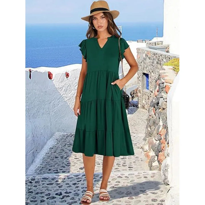 Beautiful women's elegant midi dress. Features a V-neck, tiered skirt, and stylish flutter sleeves.