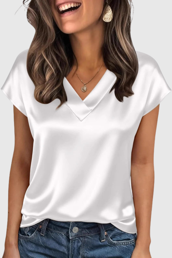 Fashionable women's V-neck blouse, designed for summer wear. Elegant short sleeve top for versatile day-to-night style.
