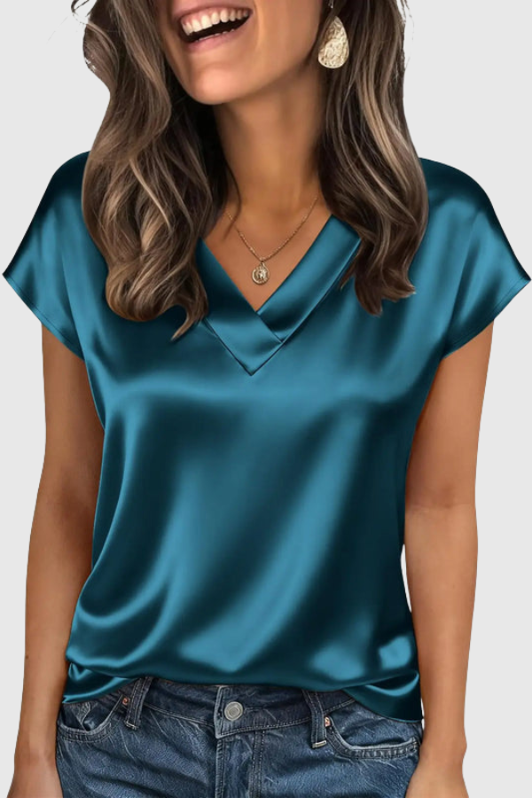 Chic V-neck women's blouse with short sleeves. Elegant summer top offering a comfortable, loose fit for all occasions.