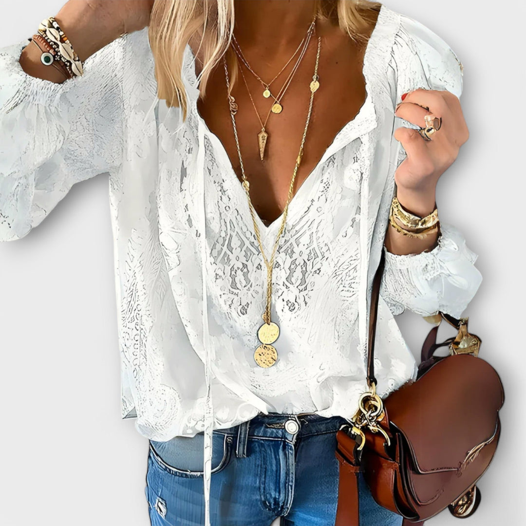 Elegant white Brunetta blouse for women with a chic tie-neck design and flowing long sleeves, perfect for spring fashion.