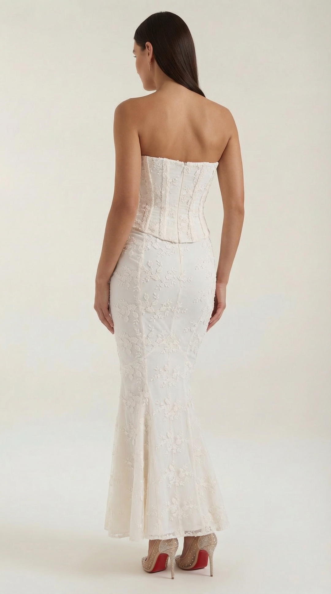 White strapless corset maxi dress with delicate lace details, ideal for a formal wedding guest.