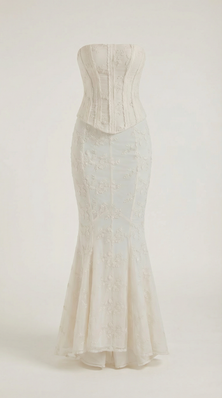 Formal white mermaid style strapless maxi dress with corset bodice & intricate lace fabric.