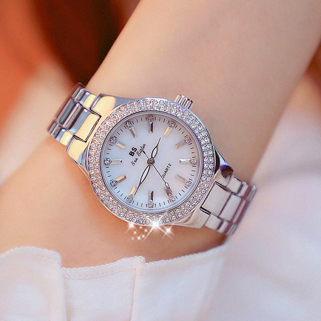 Elegant women's 1.26" stainless steel quartz watch with a classic silver-tone finish. Perfect fashion accessory.
