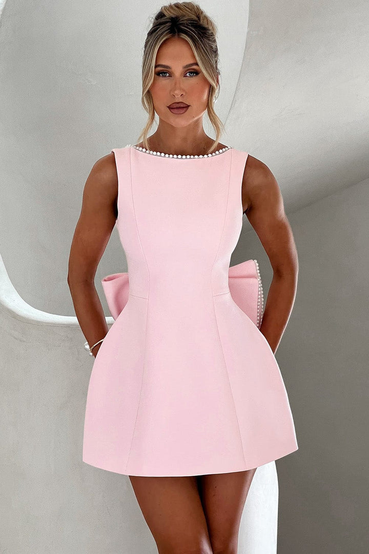 Elegant Women's A-line mini dress with pearl trim & statement bow. Perfect for cocktail parties & special occasions.