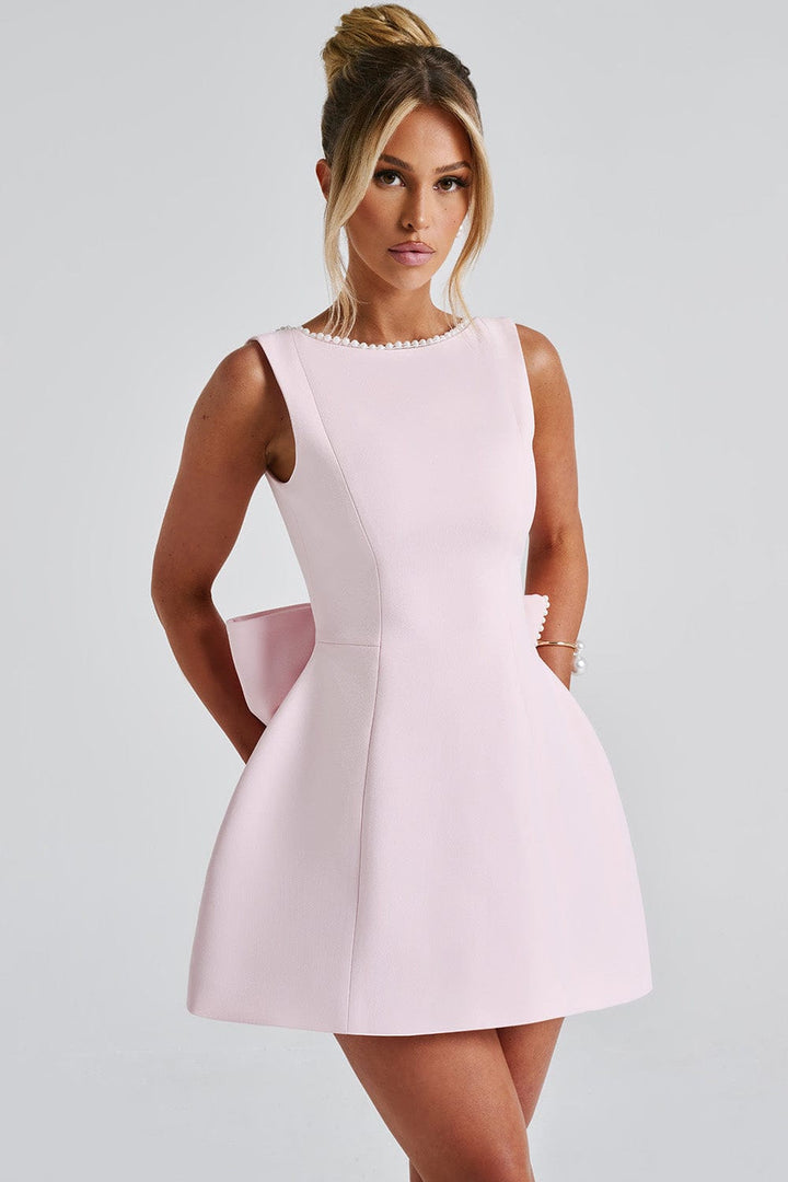 Stylish A-line mini dress for women, with delicate pearl trim and a unique statement bow. Great for special events.