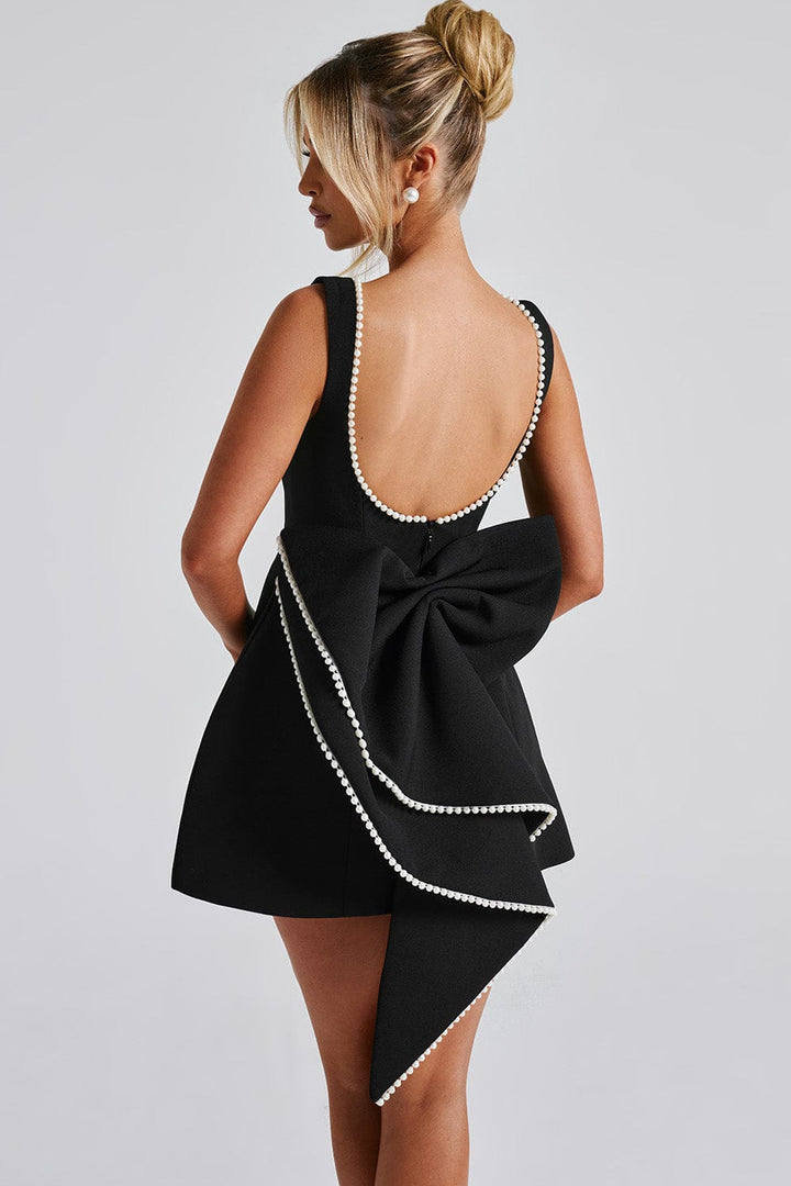 Sophisticated women's A-line mini dress, luxurious design with elegant pearl trim & a bold statement bow. Party ready.