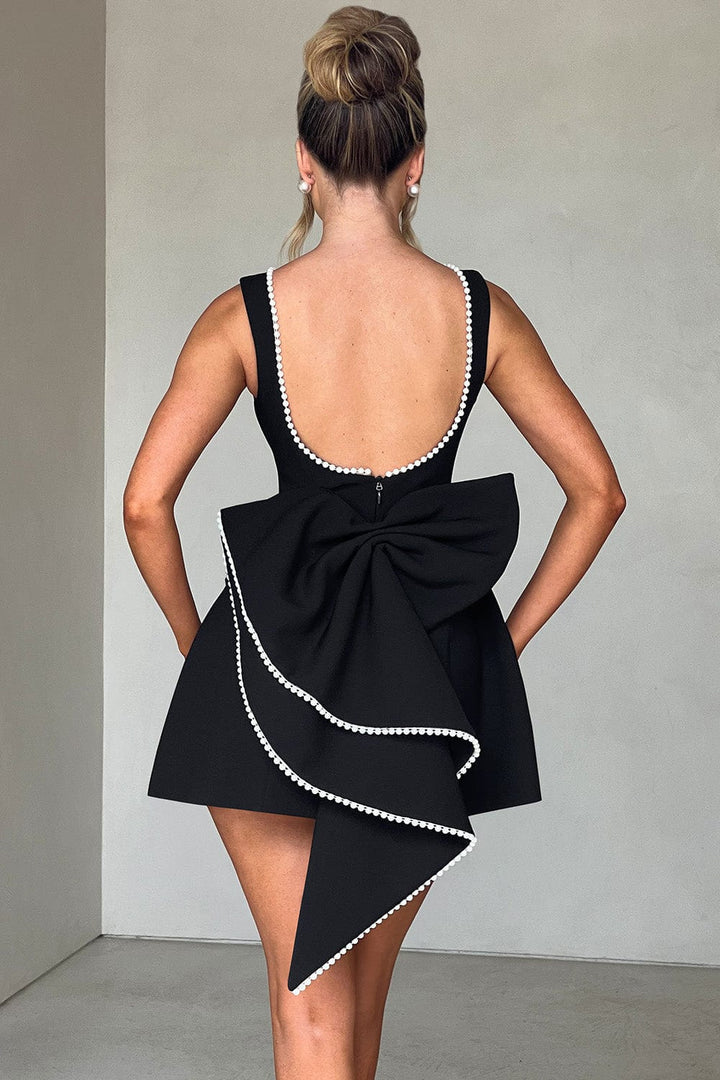 Special occasion A-line mini dress for women, featuring elegant pearl trim and a stunning statement bow detail.