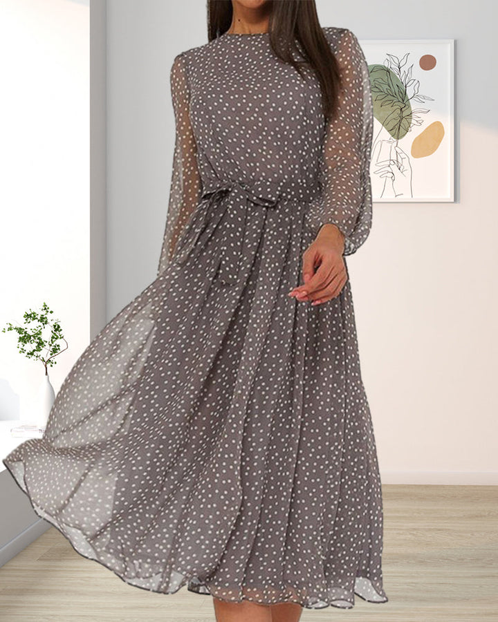 Stylish knee-length A-line dress for women, with charming polka dot pattern and distinctive lantern sleeves.