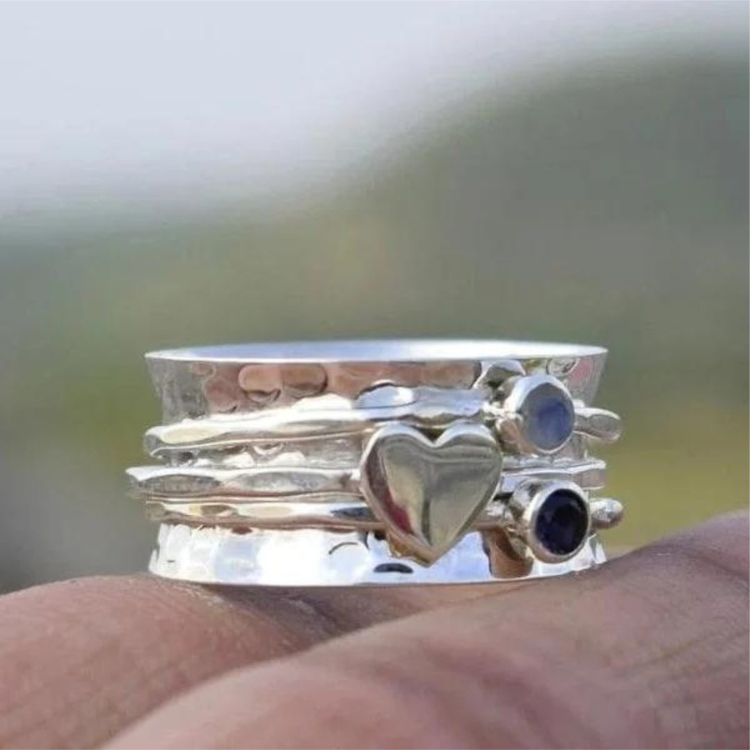 Elegant women's artisan silver heart spinner ring for everyday wear, a fashionable and stackable jewelry accessory.