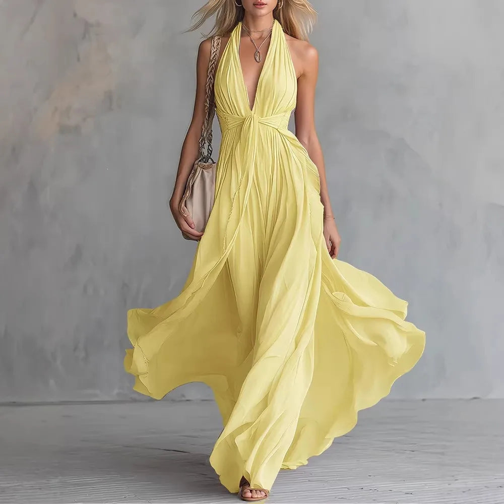 Formal women's backless halter maxi dress. Features a stylish side slit and elegant flowing fabric for events.
