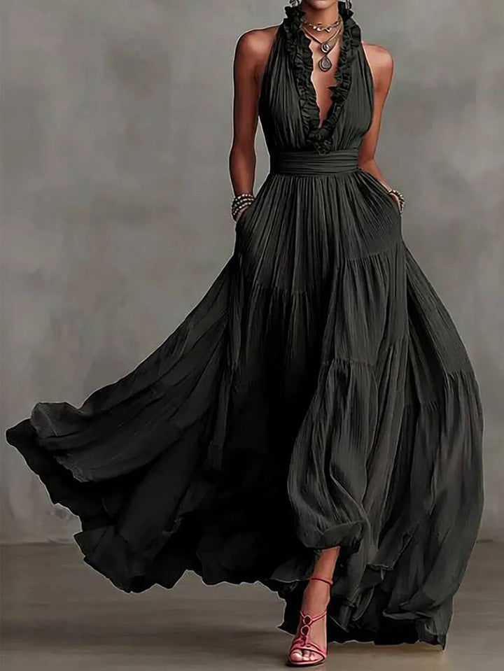 Formal women's maxi dress with plunging neckline & pleated skirt, ideal for wedding guests & events.