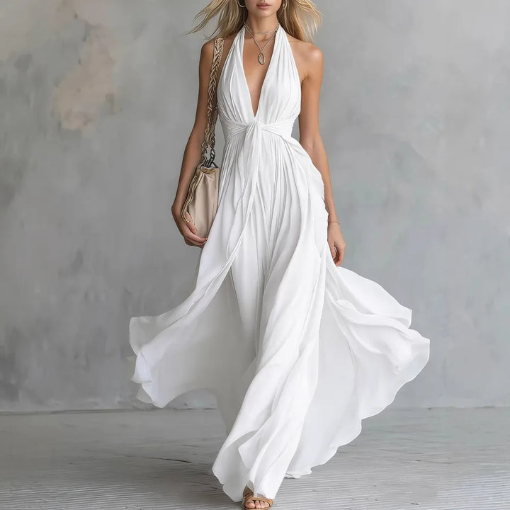 Stunning women's flowy pleated maxi evening gown, backless design & halter neck for special occasions.