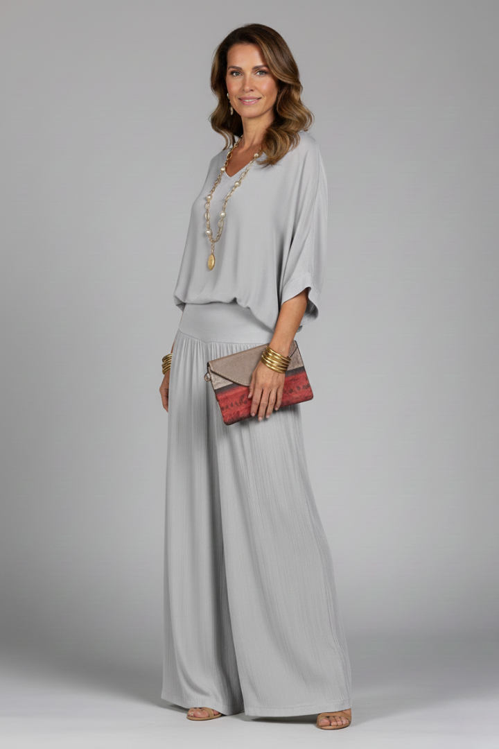 Full view of women's elegant two-piece set: batwing top & wide leg pants, ideal for summer parties.