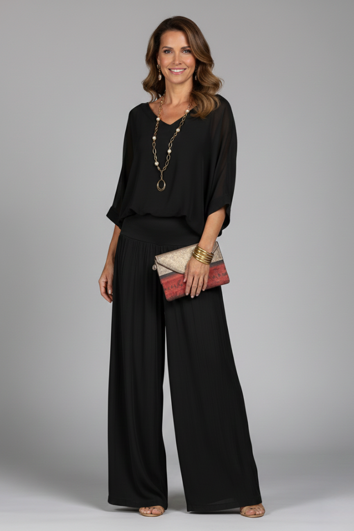 Close-up of elegant batwing sleeve on women's chic two-piece top, part of a pant set.