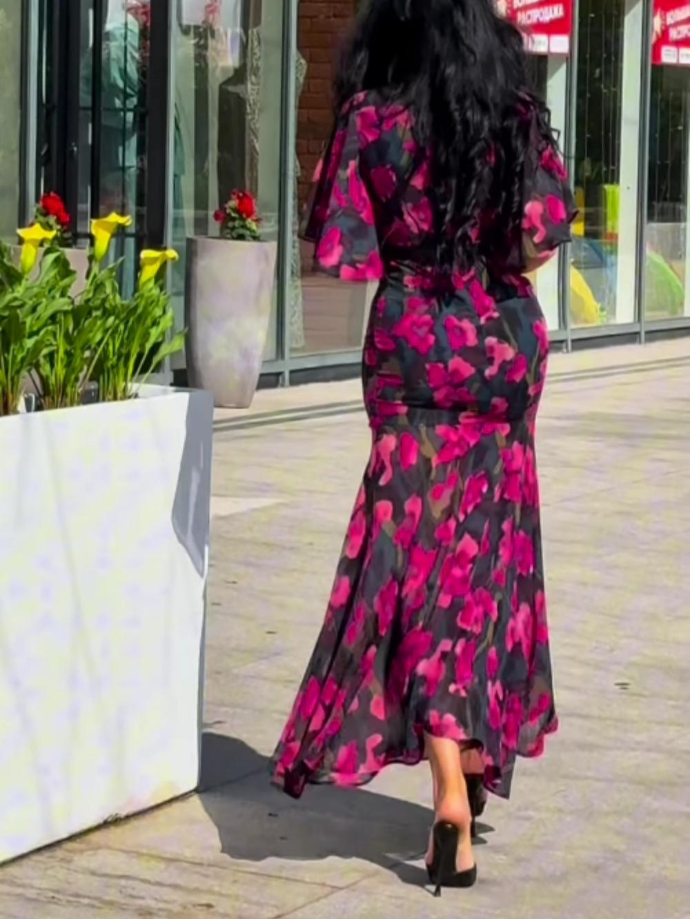 Bohemian black floral maxi dress for women, featuring a flattering V-neck, graceful trumpet sleeves & flowy skirt.