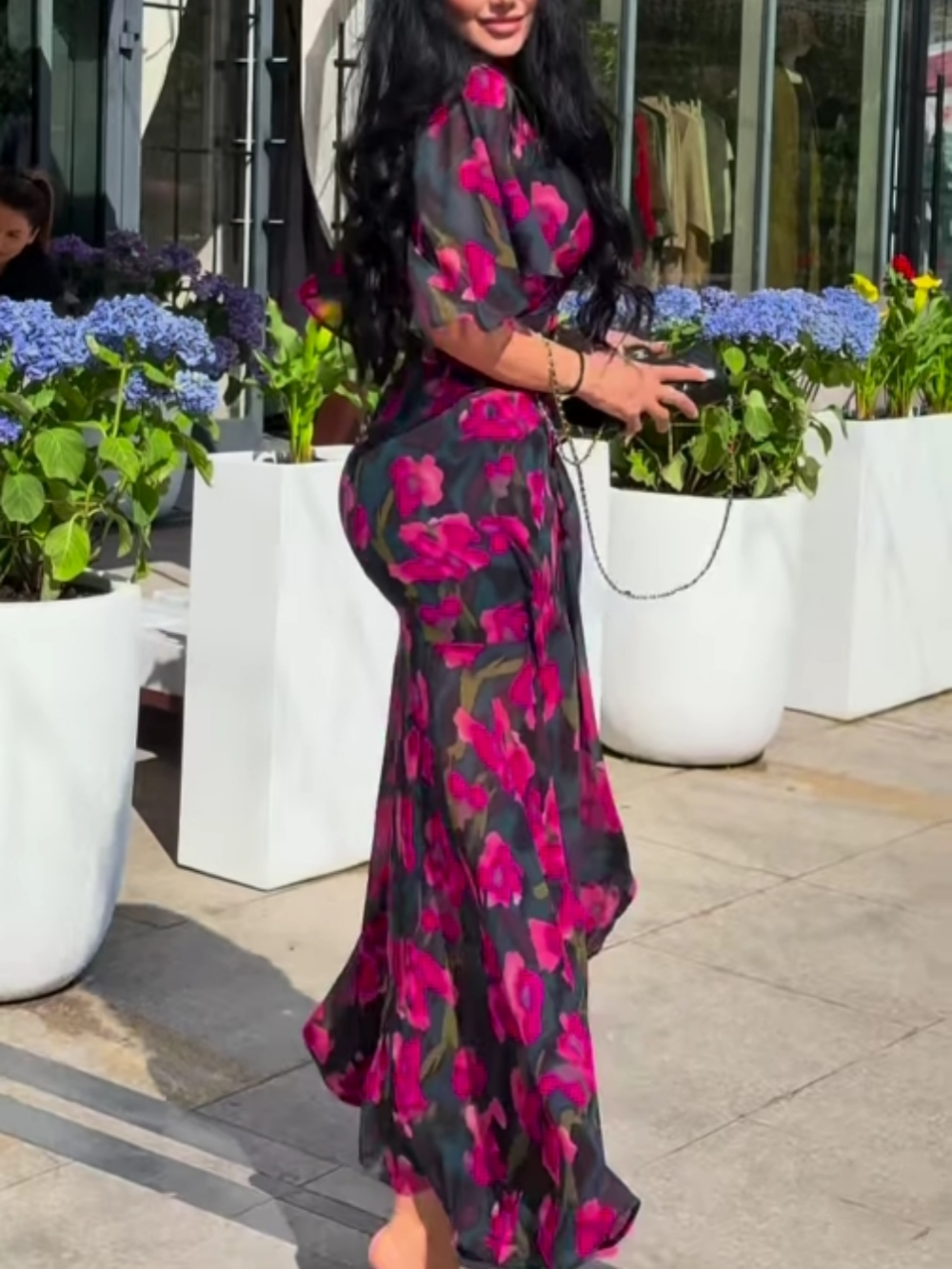 Feminine black floral maxi dress with V-neck and elegant trumpet sleeves, a versatile choice for summer fashion.