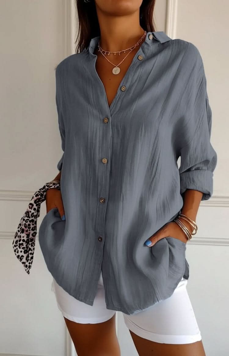 Light-colored elegant women's blouse with long sleeves, a chic and versatile top for any occasion.