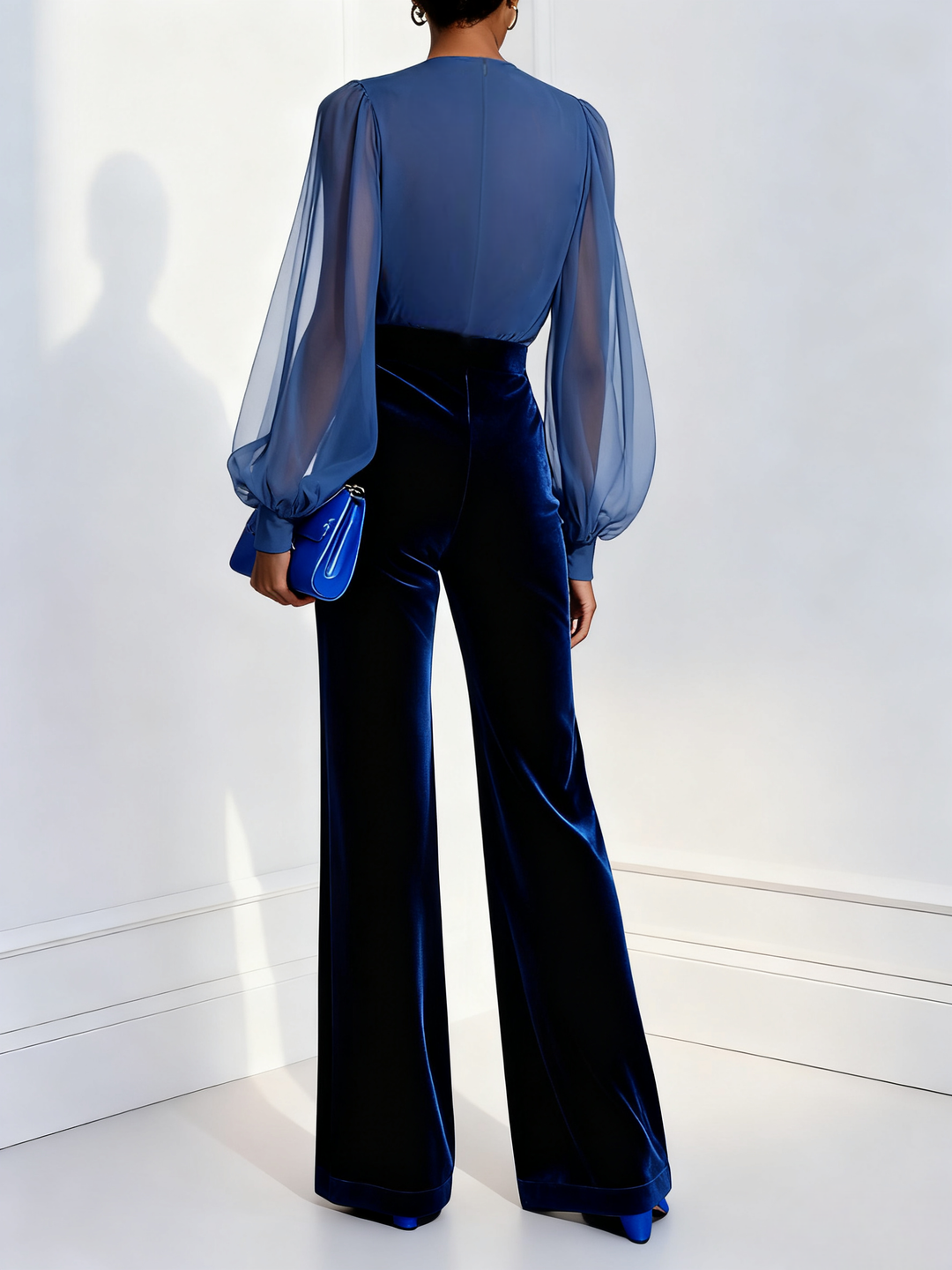 Sophisticated blue long-sleeve jumpsuit for women, featuring a chic sheer V-neck, ideal for cocktail & formal wear.