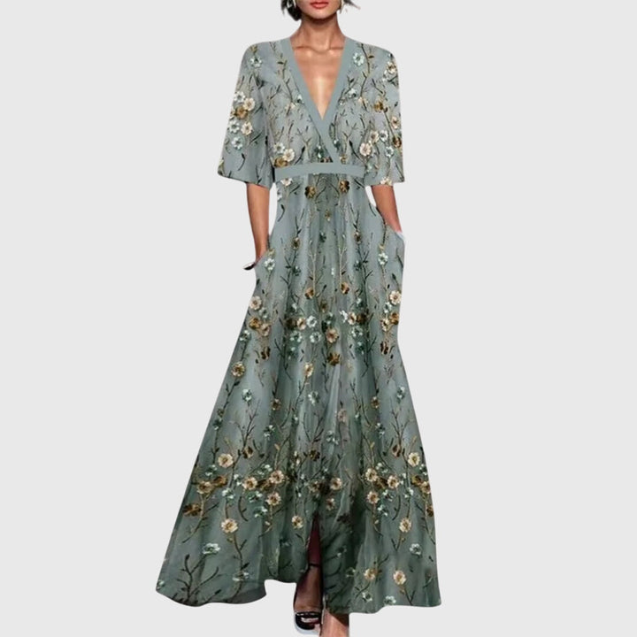 Women's vibrant floral A-line maxi dress with deep V-neck and flowy skirt. Ideal for elegant parties or wedding guests.