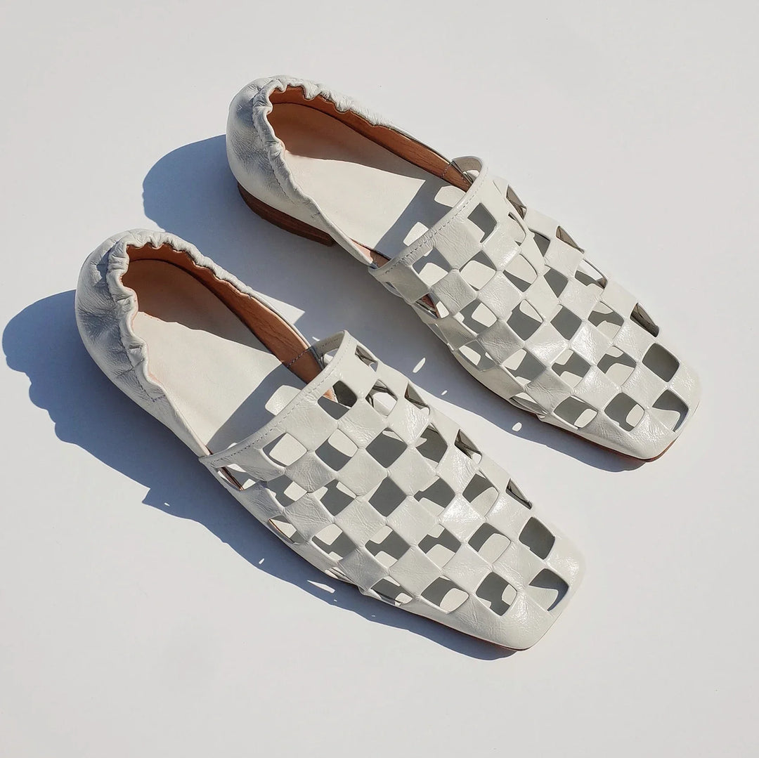 Back view of women's elegant checkered leather mules, presenting their streamlined and fashionable look.