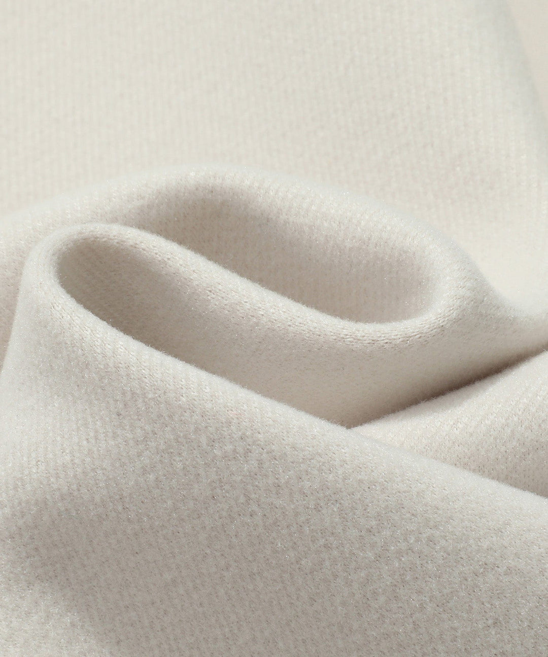 Close-up of the double-breasted detail on a white women's trench coat, highlighting the style.