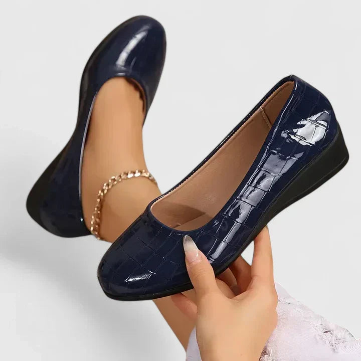 Stylish women's slip-on wedge loafers featuring luxurious croc embossed texture and comfortable square toe design.