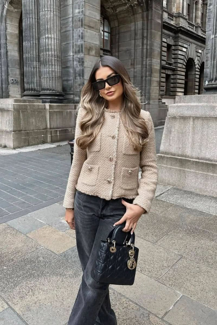 Women's elegant cropped button blazer, a versatile layering piece for sophisticated outfits.