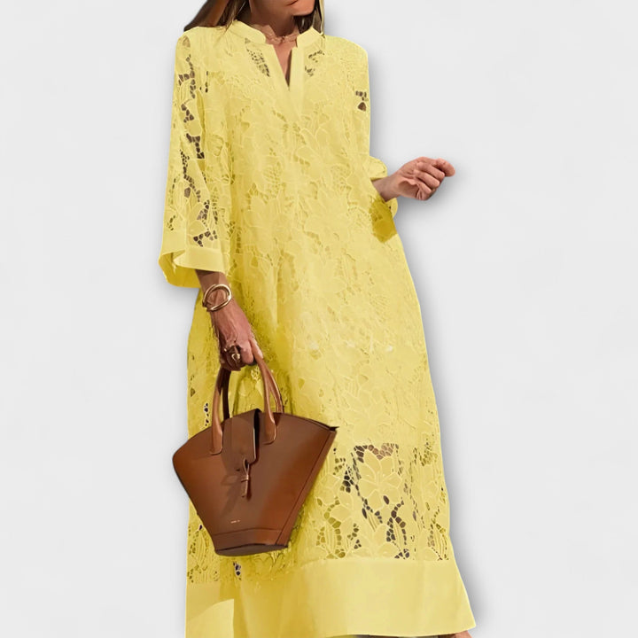 Intricate Dahlia floral embroidery on a women's short-sleeve dress, offering an elegant look for occasions.