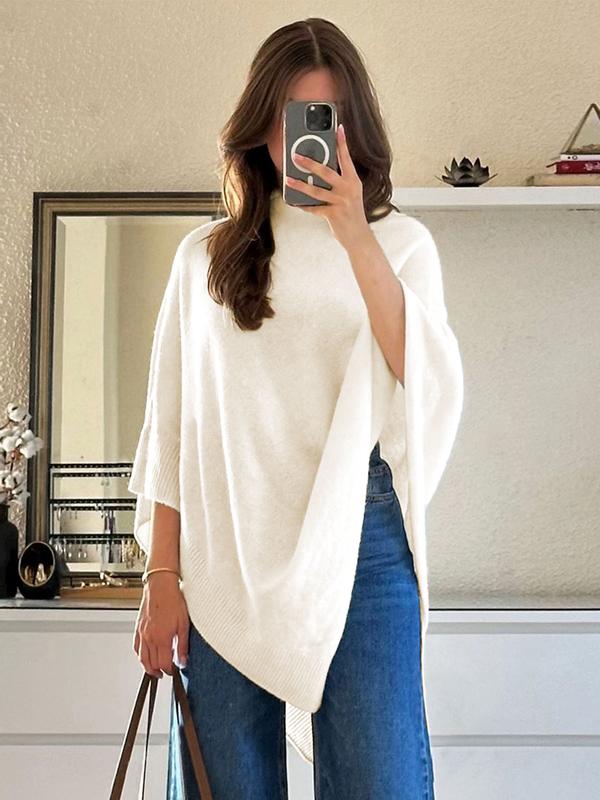 Elegant women's draped cape poncho in ivory. Stylish, versatile outerwear for effortless layering and chic fashion.