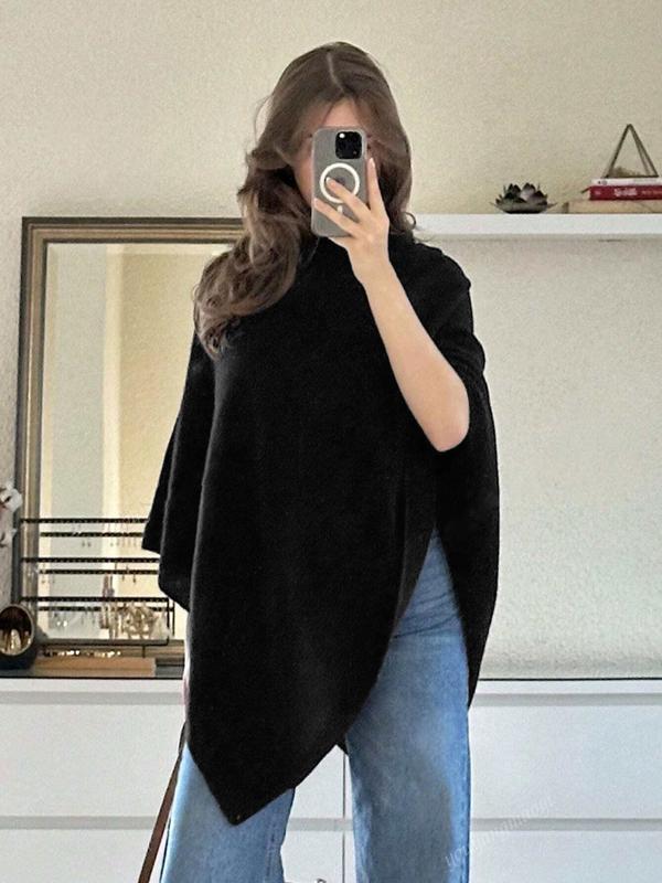 Women's black asymmetric draped cape poncho. Comfortable, elegant outerwear, perfect for stylish layering.