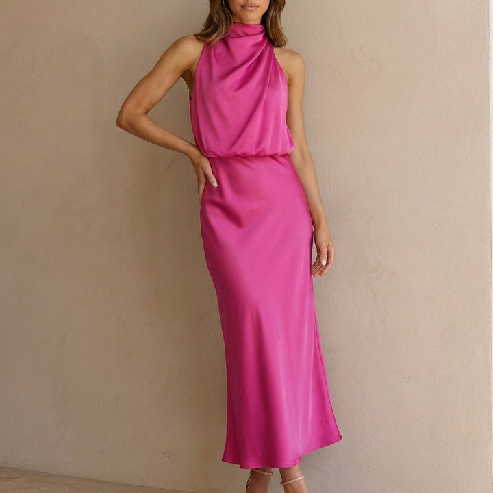 Chic women's gala dress, sleeveless and draped, with a sophisticated halter neckline and blouson waist.