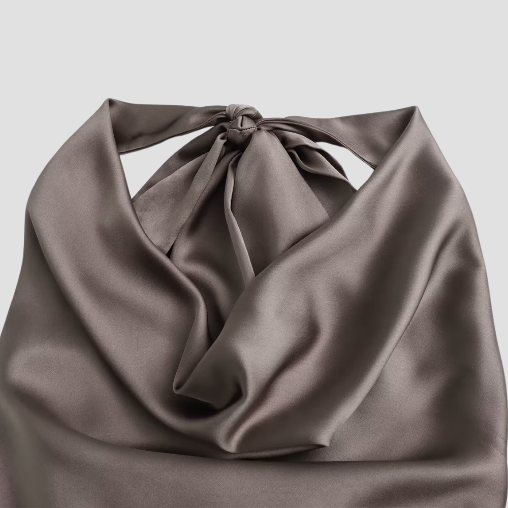 Sophisticated women's halter neck tank top, featuring a stylish drape. Great for chic summer fashion.