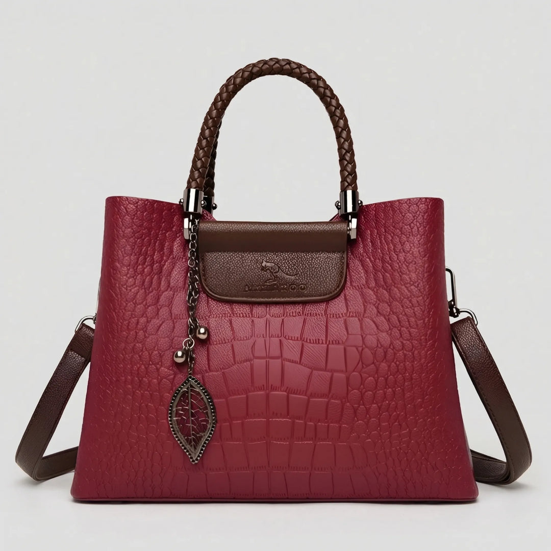 Chic embossed handbag for women featuring a distinctive braided handle; a stylish and classic tote for any outfit.