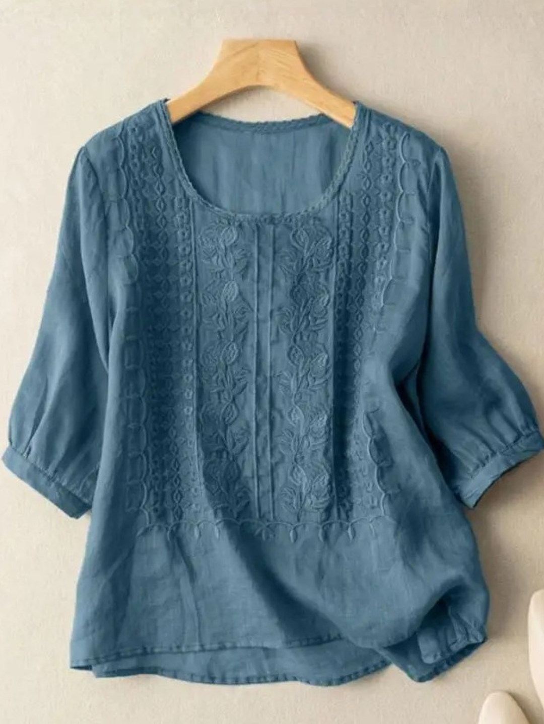 Stylish women's embroidered top with a relaxed fit, ideal for elegant casual wear and fashion-forward spring looks.