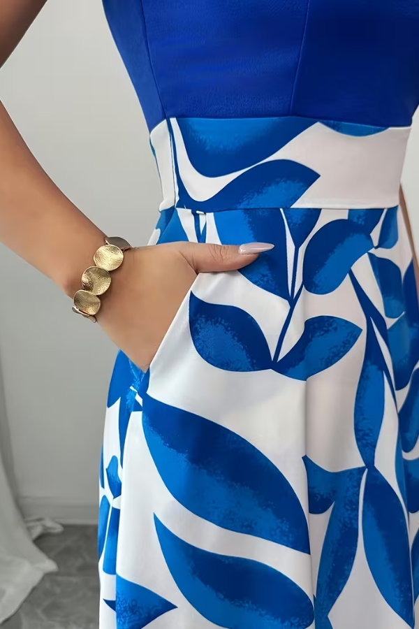 Flowy women's elegant A-line maxi dress with a beautiful floral pattern, v-neck, and practical pockets for summer.